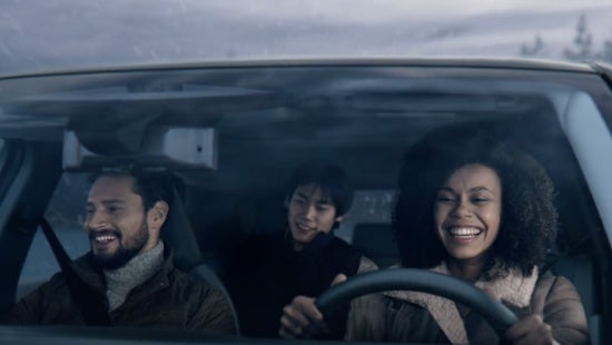 Three passengers riding in a vehicle and smiling | Barberino Nissan in Wallingford CT