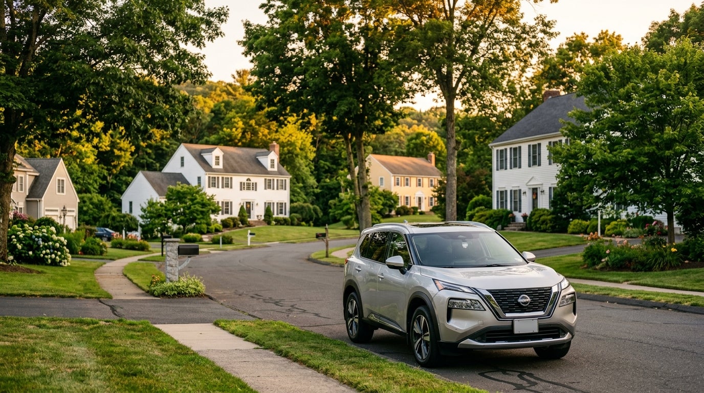 Silver Nissan SUV parked on a quiet, tree-lined suburban street with colonial houses. (Representative image for illustration purposes only. Actual vehicle may vary based on trim and configuration.)