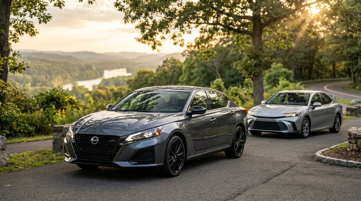 Dark grey Nissan Altima and silver Toyota Camry parked on a scenic road overlooking a river valley at golden hour. (Representative image for illustration purposes only. Actual vehicle may vary based on trim and configuration.)