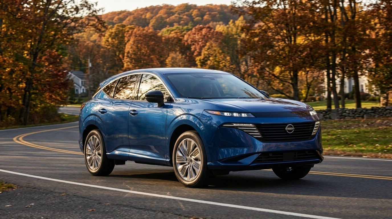 Blue Nissan crossover SUV navigating a winding road framed by vibrant autumn foliage. (Representative image for illustration purposes only. Actual vehicle may vary based on trim and configuration.)